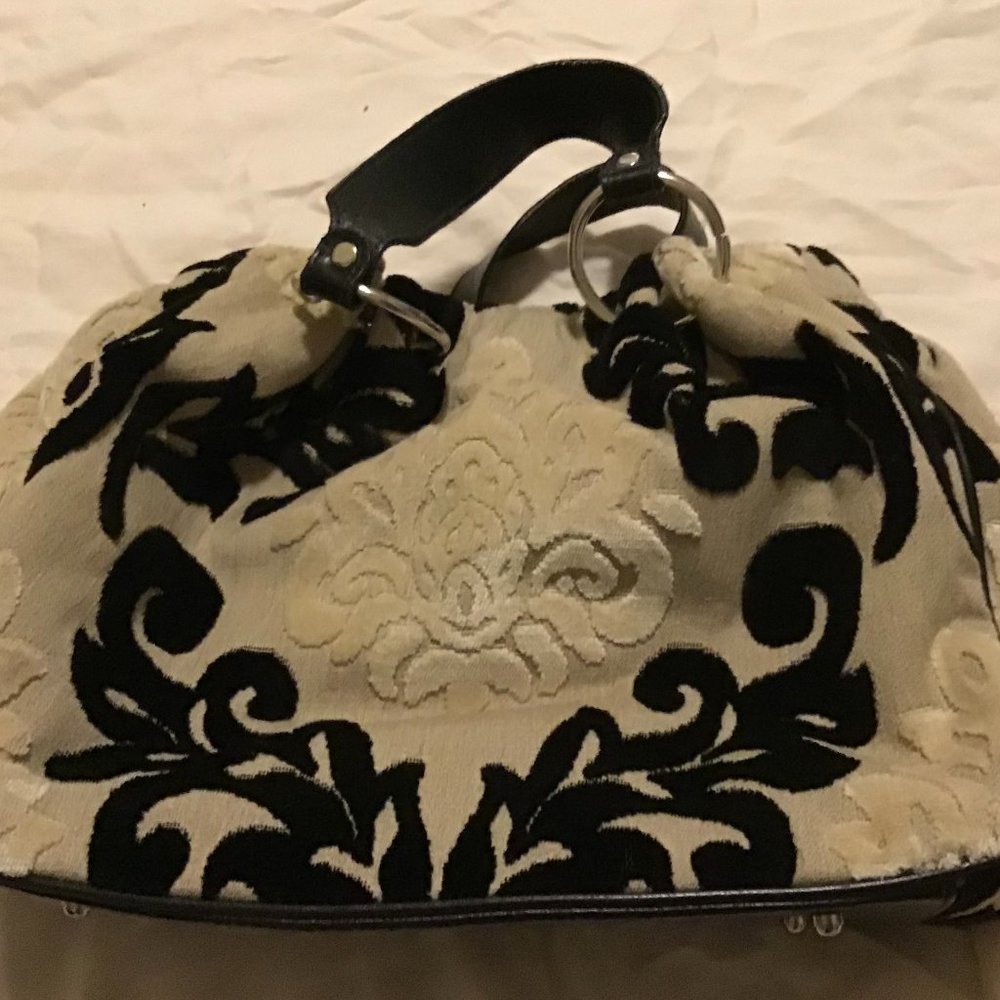 White and black purse with black handles